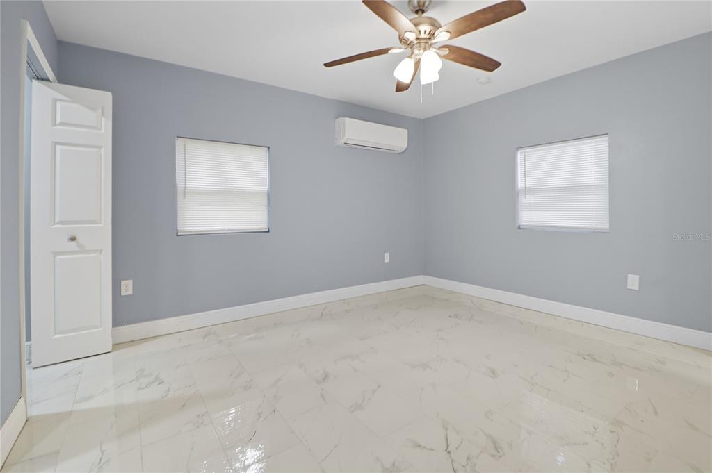 2011 East 148th Avenue Lutz, FL 33559 - Photo 32 of 37 en empty room with windows and fan