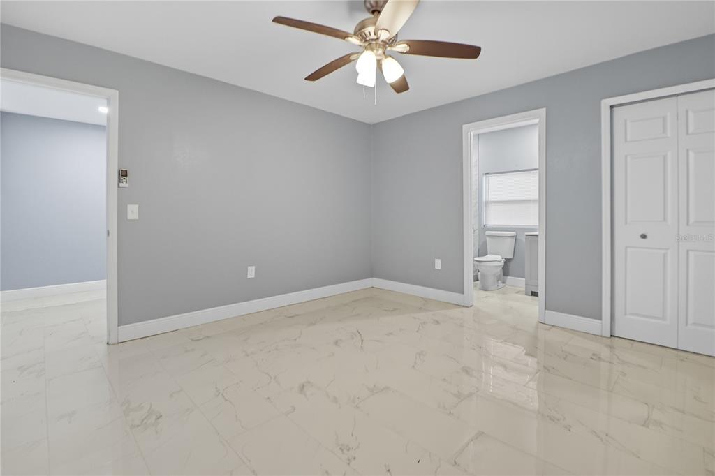 2011 East 148th Avenue Lutz, FL 33559 - Photo 33 of 37 an empty room with chandelier fan and windows