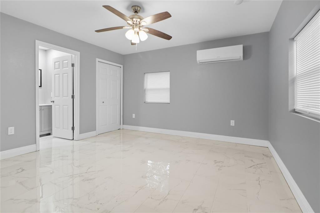 2011 East 148th Avenue Lutz, FL 33559 - Photo 34 of 37 an empty room with windows and fan