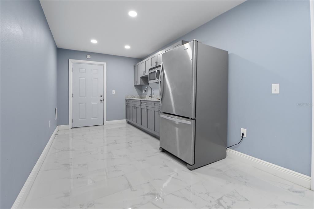 2011 East 148th Avenue Lutz, FL 33559 - Photo 35 of 37 a view of kitchen with refrigerator and microwave