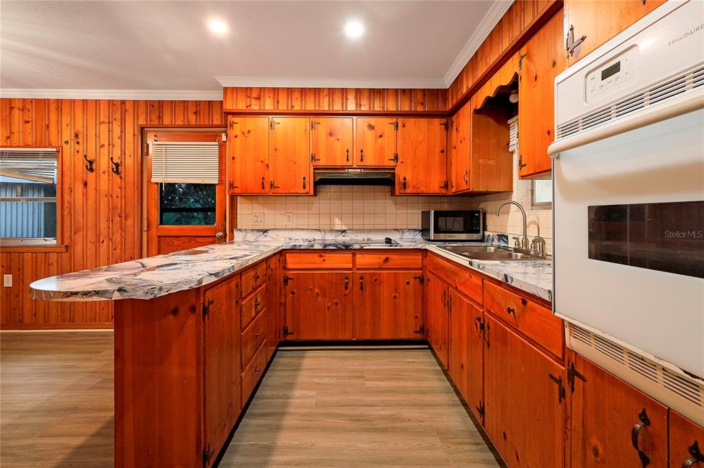 2011 East 148th Avenue Lutz, FL 33559 - Photo 6 of 37 a kitchen with stainless steel appliances granite countertop a stove a sink and a refrigerator