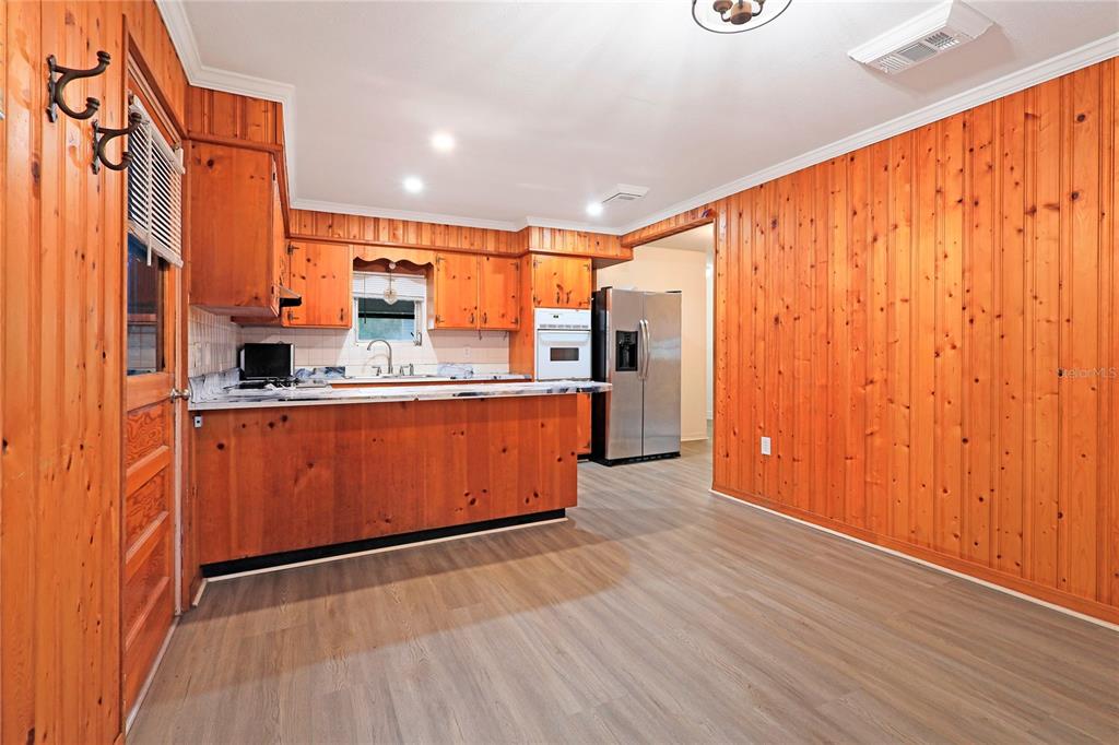 2011 East 148th Avenue Lutz, FL 33559 - Photo 8 of 37 a kitchen with stainless steel appliances granite countertop a refrigerator a sink and wooden floors