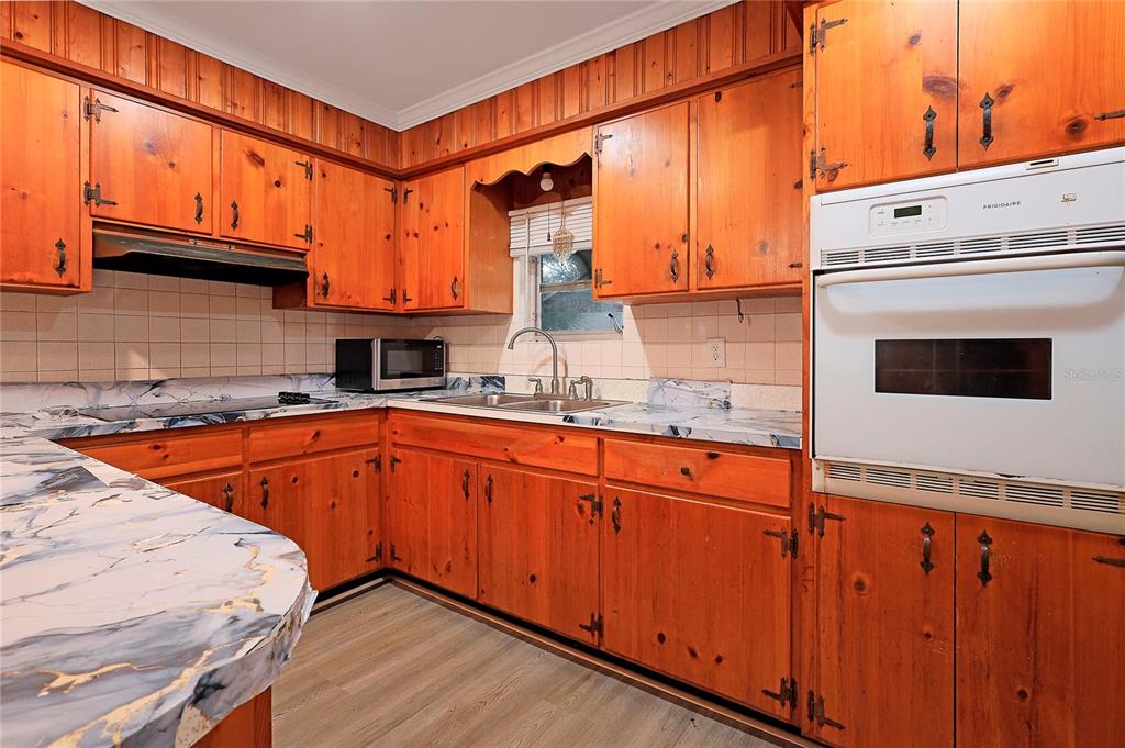 2011 East 148th Avenue Lutz, FL 33559 - Photo 9 of 37 a kitchen with stainless steel appliances granite countertop a sink a stove and cabinets