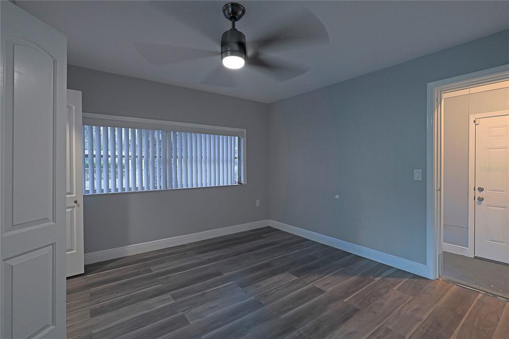 2011 East 148th Avenue Lutz, FL 33559 - Photo 10 of 37 wooden floor in an empty room with a window