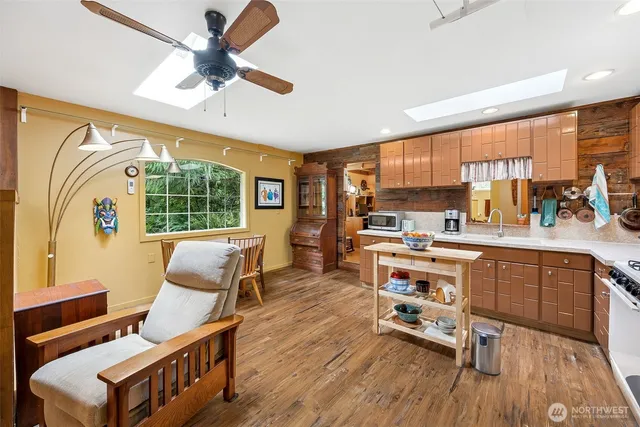 a kitchen with a sink a stove cabinets and dining table