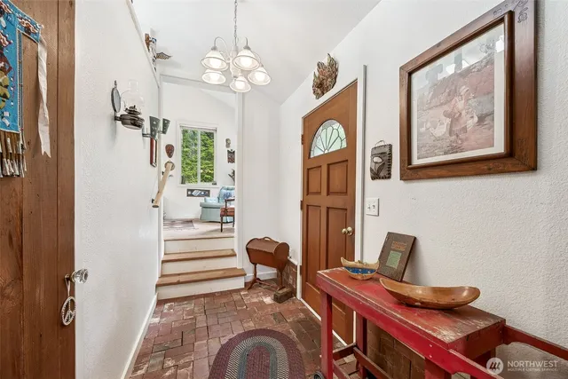a living room with furniture a fireplace and a chandelier
