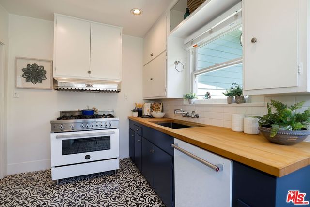 a kitchen with a sink stove and cabinets