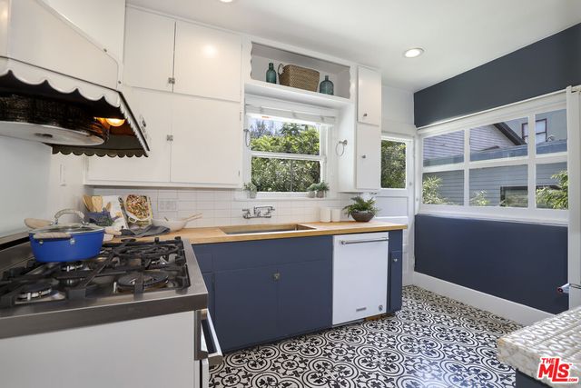 a kitchen with a sink and wooden cabinets