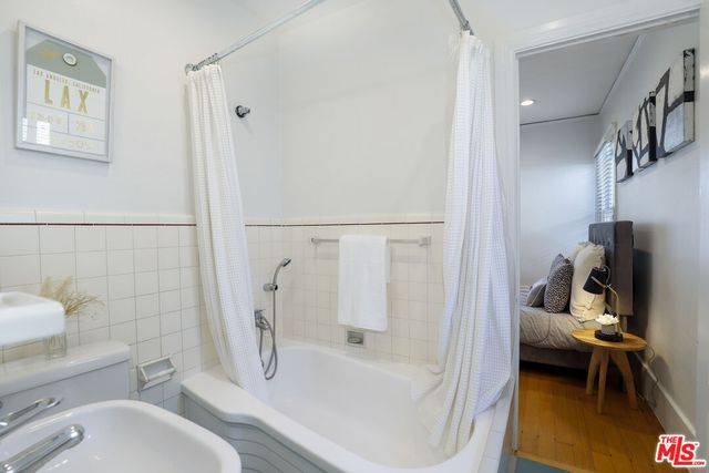 a bathroom with a tub toilet and a shower