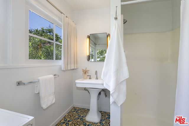 a bathroom with a sink toilet and a mirror