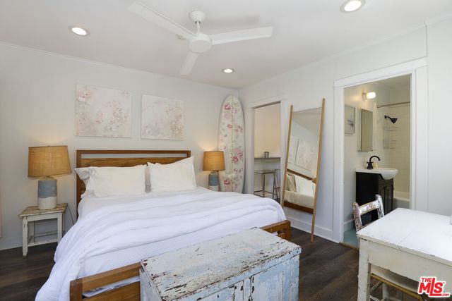 a bedroom with a bed and a view of kitchen