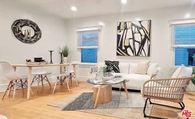 a living room with furniture a rug and a window