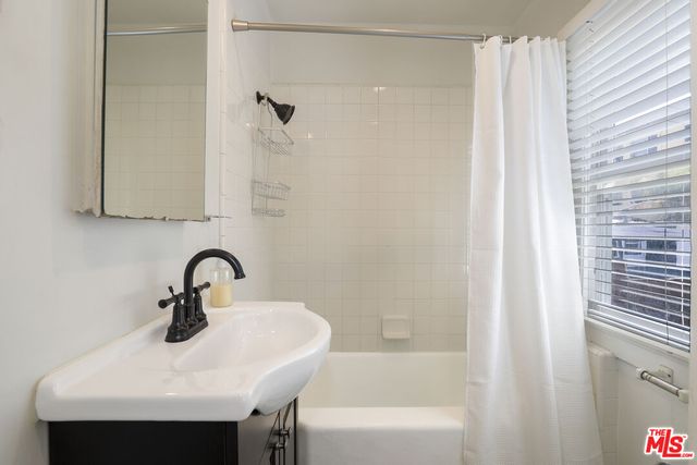 a bathroom with a sink a bathtub and a shower