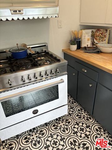 a kitchen with a stove and cabinets