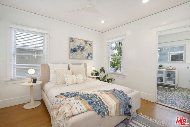 a bedroom with a large bed and a window