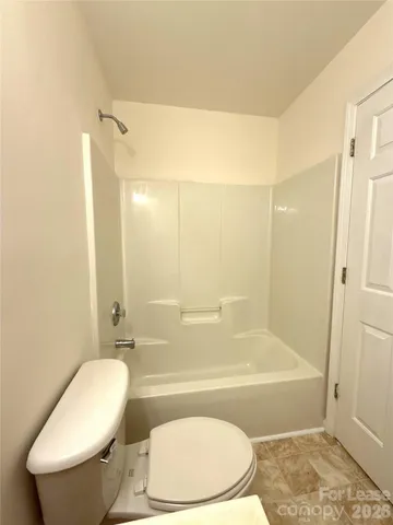 a bathroom with a toilet and bathtub
