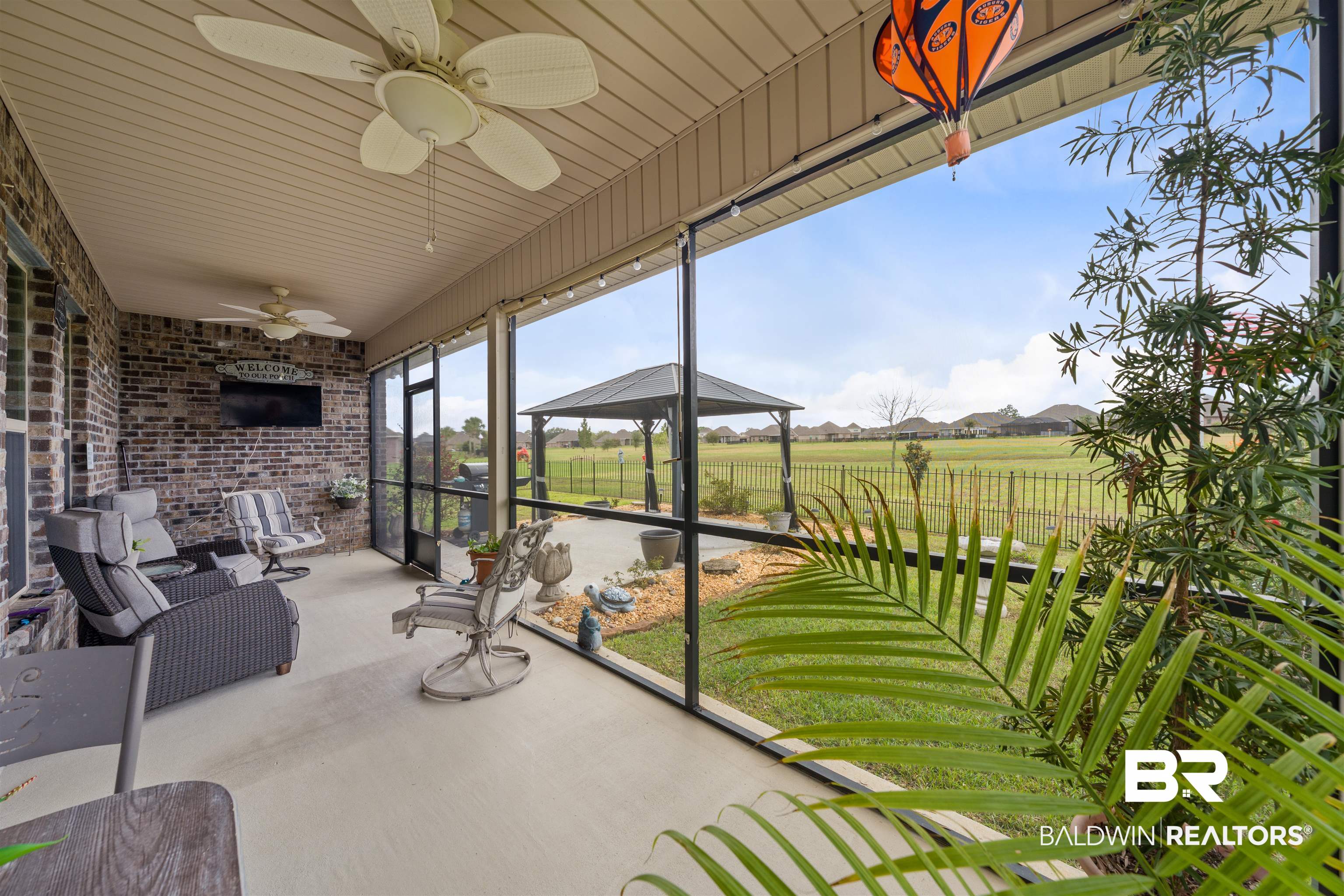 22512 Putter Lane Foley, AL 36535 - Photo 18 of 27 Sunroom featuring a ceiling fan and a residential view