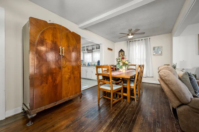 a dining room with furniture and wooden floor
