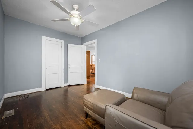 a living room with furniture and a ceiling fan