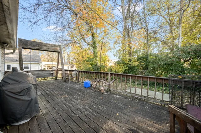 a view of roof deck with wooden floor and seating space
