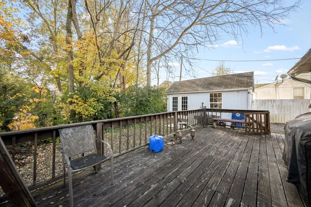 a view of roof deck with wooden floor and seating space