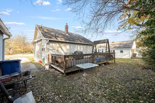 a view of a house with a yard deck and furniture