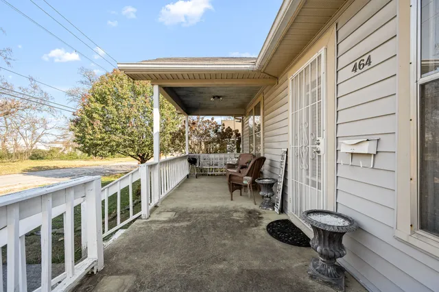 a view of a porch with chairs and a yard