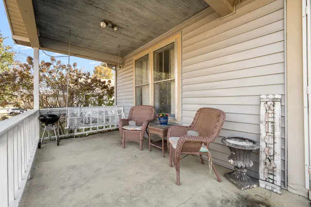 a balcony with chairs and a table