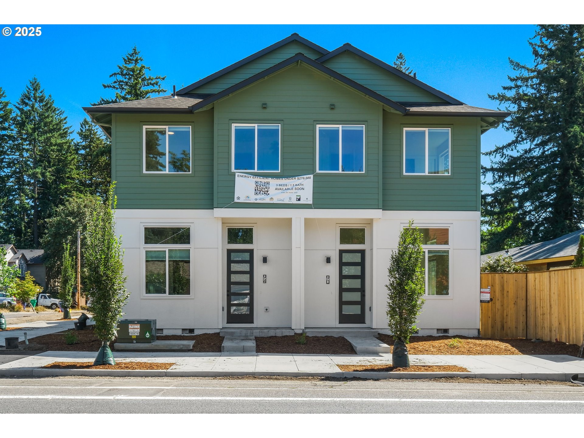 14858 Northeast Couch Street, Unit 10 Portland, OR 97230 - Photo 40 of 42 a front view of a house with a yard