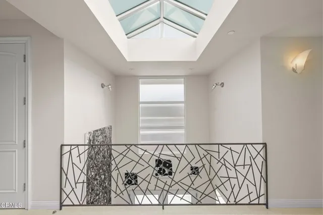 a bedroom with furniture and a large window