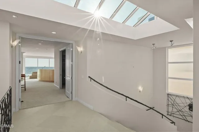 a balcony with furniture and a floor to ceiling window