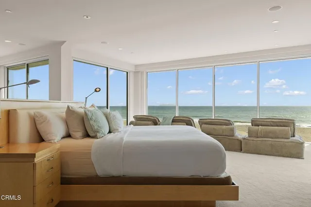 a bed sitting in a bedroom next to a window