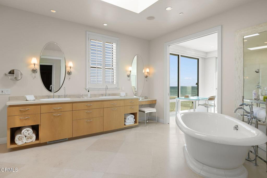 1135 Capri Way Oxnard, CA 93035 - Photo 37 of 62 a spacious bathroom with a double vanity sink a mirror and a bathtub