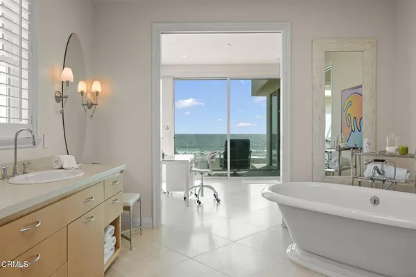 a kitchen with white cabinets and window