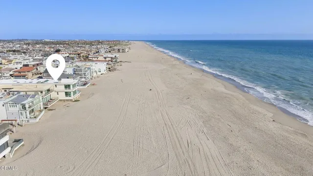 a view of a hallway with wooden floor and entryway