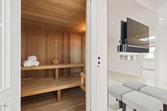 a white bath tub sitting next to a shower