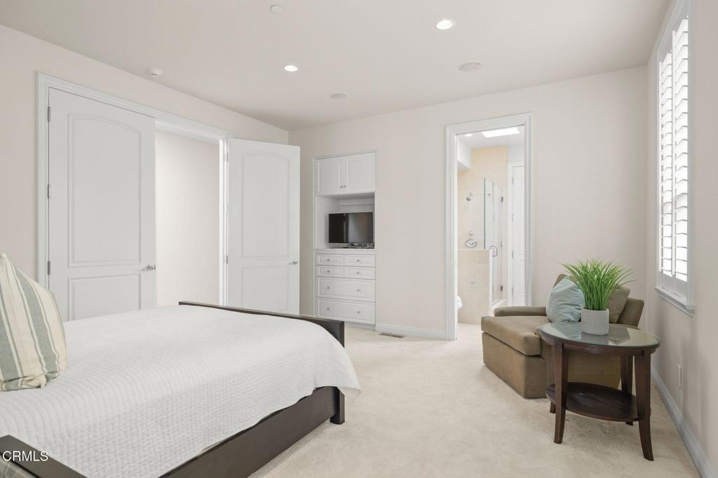 1135 Capri Way Oxnard, CA 93035 - Photo 48 of 62 a spacious bedroom with a bed and a couch