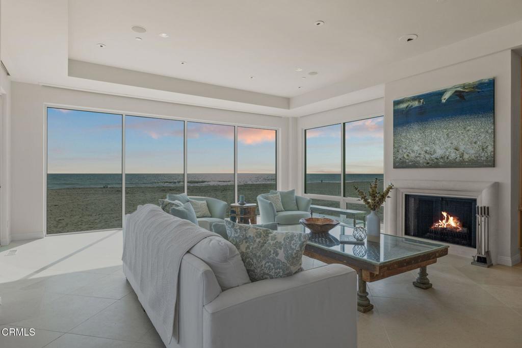 1135 Capri Way Oxnard, CA 93035 - Photo 10 of 62 a living room with furniture a fireplace and floor to ceiling window