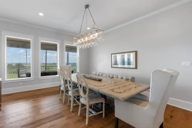 a view of a hallway with a livingroom and a bathroom with a sink