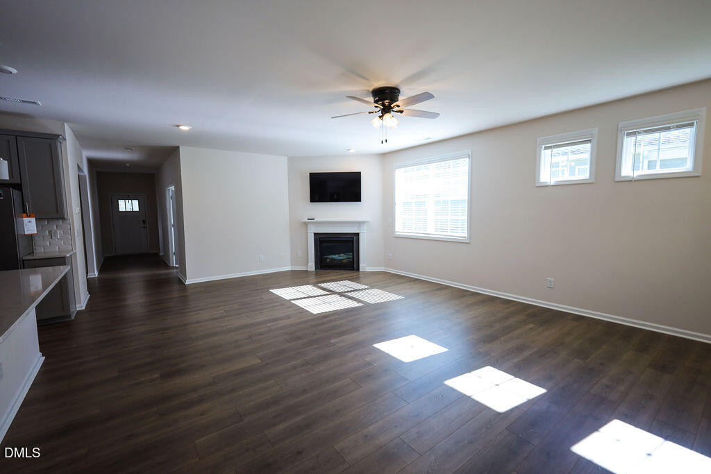 1644 Abberly Place Graham, NC 27253 - Photo 11 of 33 a view of empty room with wooden floor and fan