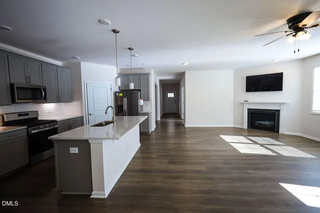 a large kitchen with cabinets a sink and a stove