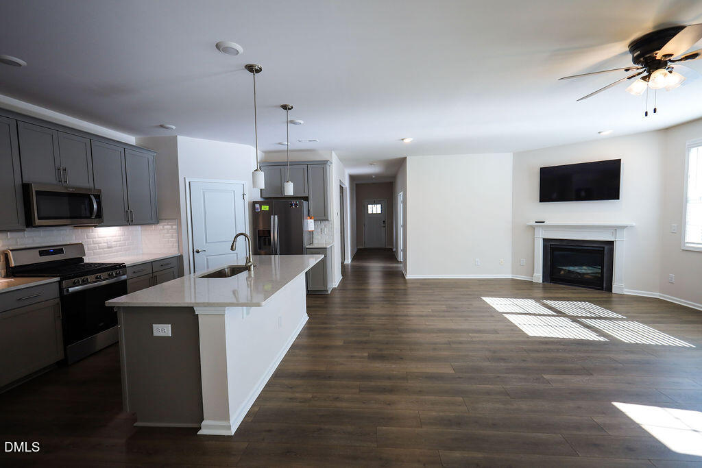 1644 Abberly Place Graham, NC 27253 - Photo 12 of 33 a large kitchen with cabinets a sink and a stove