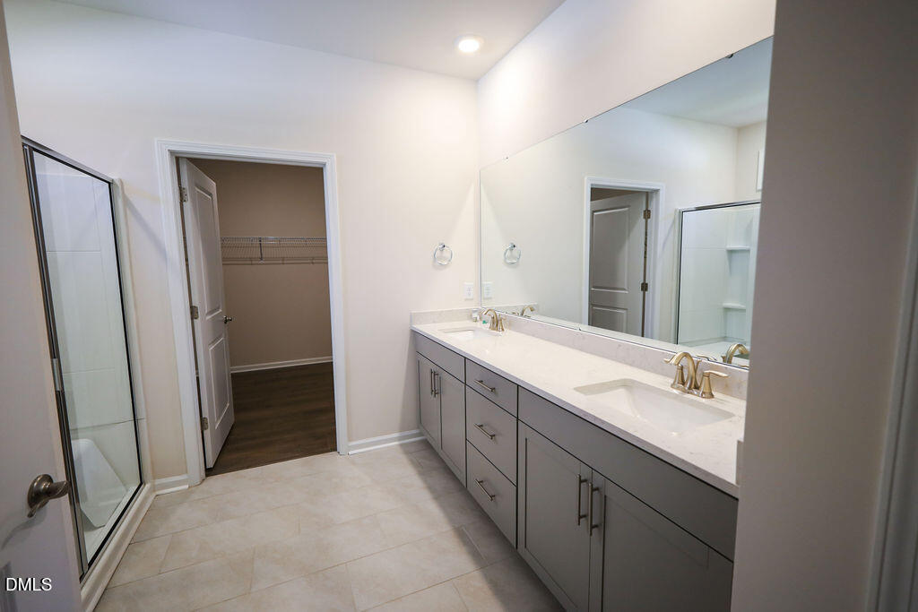 1644 Abberly Place Graham, NC 27253 - Photo 21 of 33 a bathroom with a double vanity sink and mirror