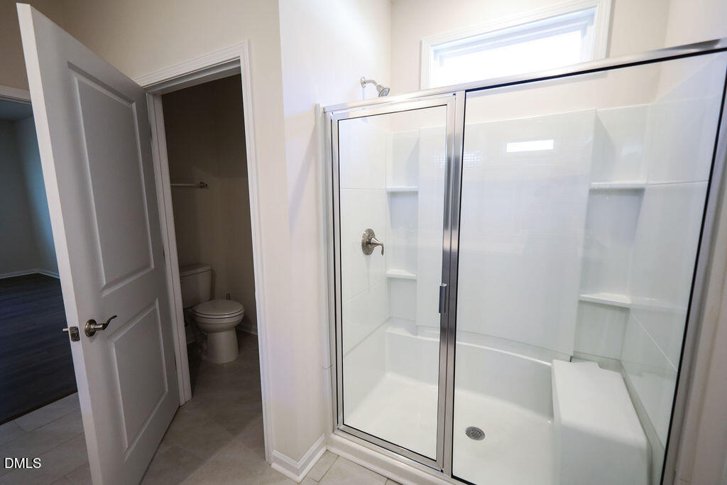 1644 Abberly Place Graham, NC 27253 - Photo 25 of 33 a bathroom with a glass shower door and a glass door shower
