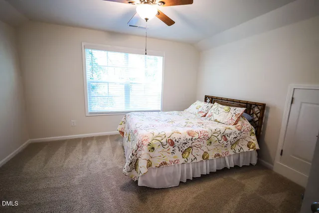 a bedroom with a bed and window
