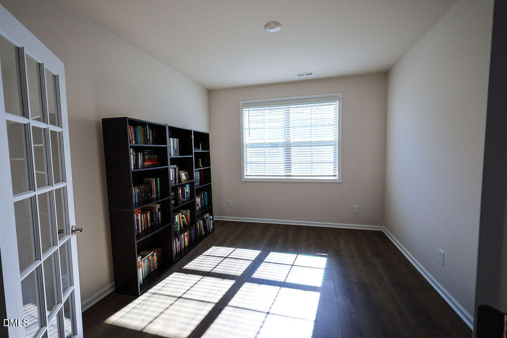 1644 Abberly Place Graham, NC 27253 - Photo 7 of 33 wooden floor in an empty room with a window
