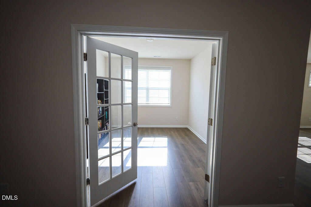 1644 Abberly Place Graham, NC 27253 - Photo 9 of 33 a view of empty room with wooden floor and fan