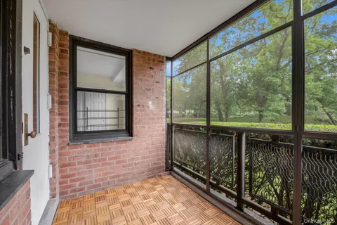 a view of a balcony with wooden floor