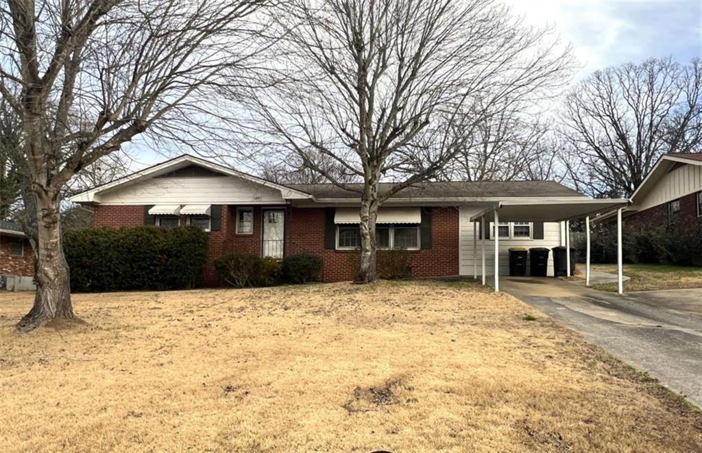 a front view of a house with a yard covered in snow