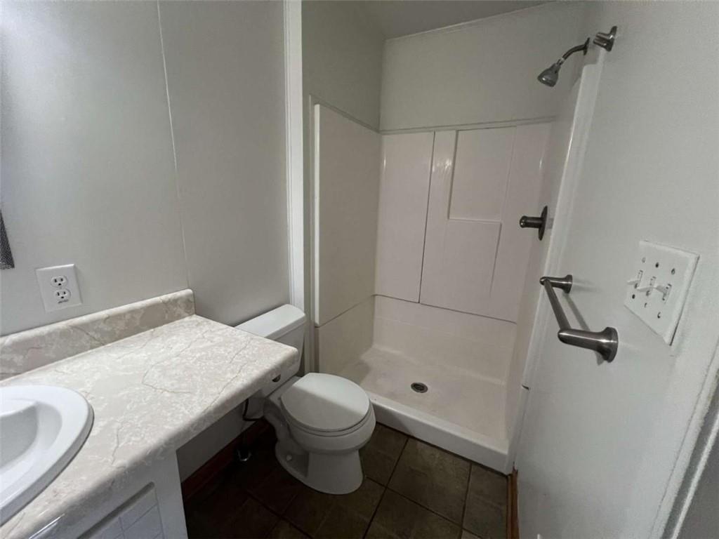 109 Chief Vann Drive Southwest Rome, GA 30165 - Photo 15 of 15 a bathroom with a granite countertop sink toilet and shower